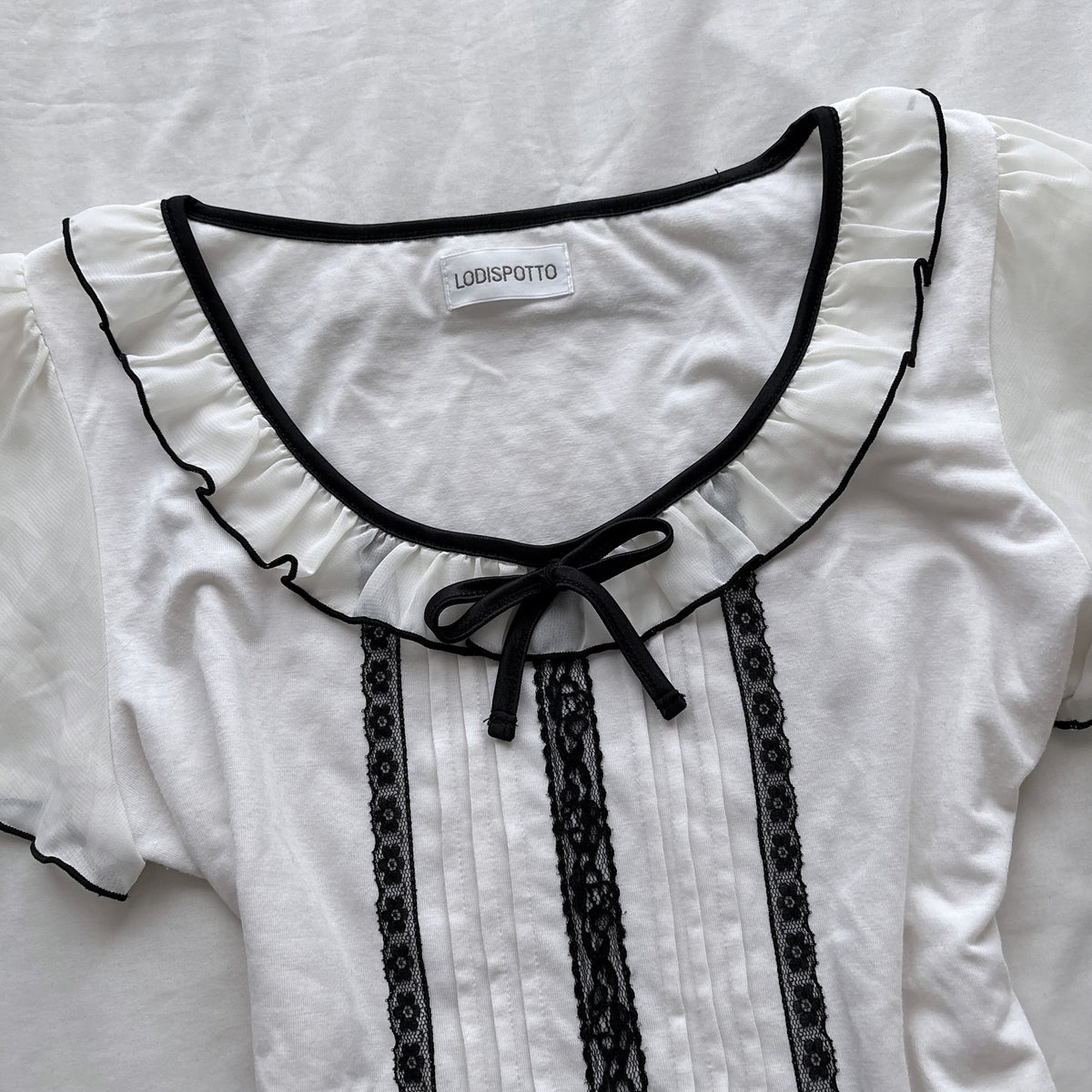 Ivory top with frilly sleeves & neckline