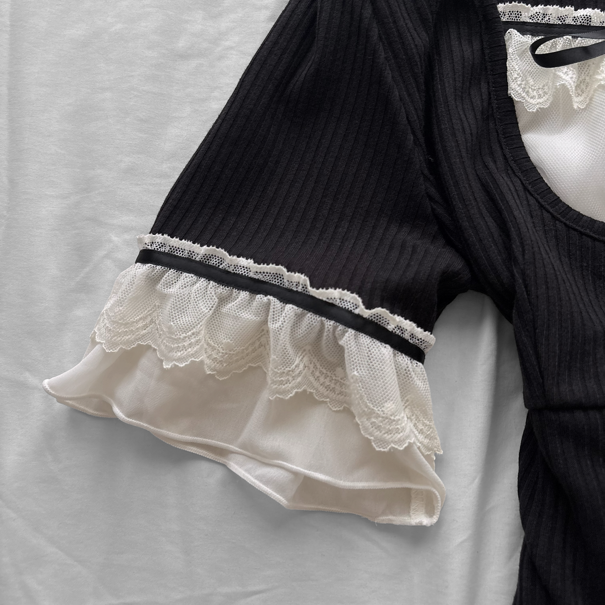‘Axes Femme’ Black Top with White Lace